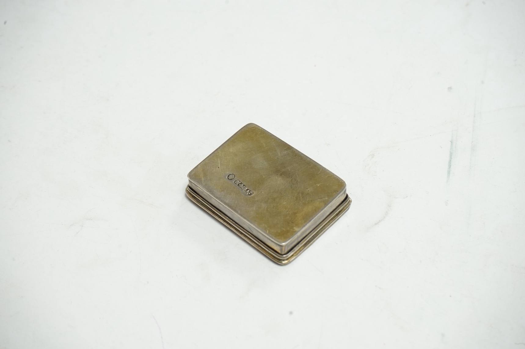 A Victorian silver gilt castle top rectangular snuff box by Nathaniel Mills, Birmingham, circa 1840, depicting a view of Kenilworth Castle, marked to base only, no date letter or assay mark, 44mm. Condition - poor to fai